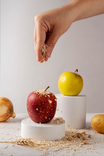 Close up hand sprinkling oats