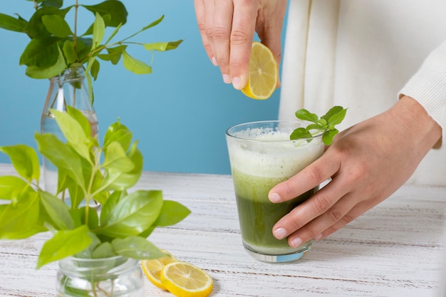 Close up hand squeezing lemon