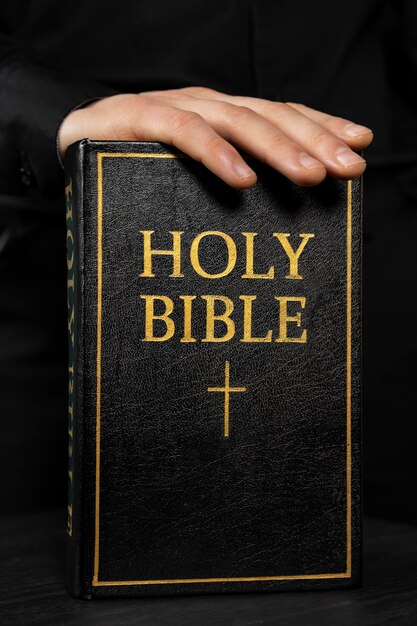 Close up hand touching holy bible