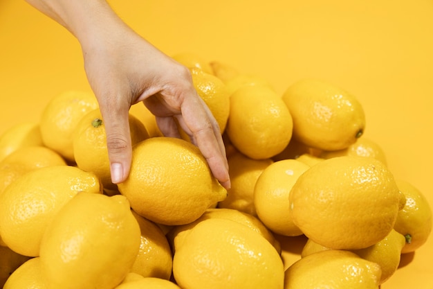 Close-up hand touching lemons