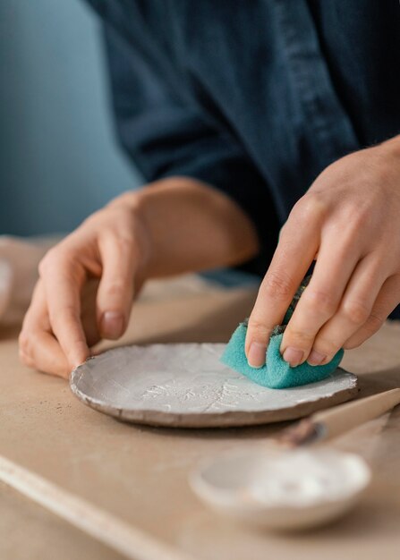 Close-up hand using blue sponge