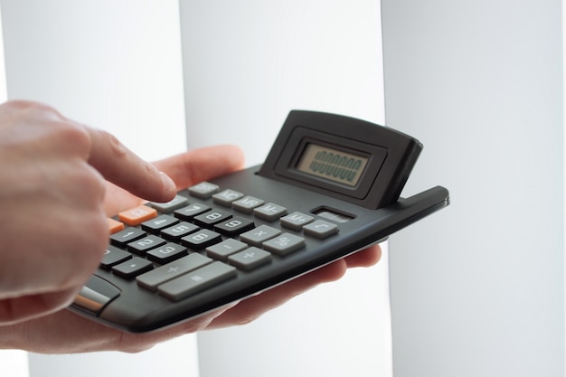 Close-up of hand using a calculator