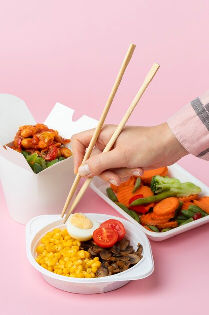 Close up hand using chopsticks