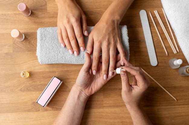 Close up hand using cuticle oil