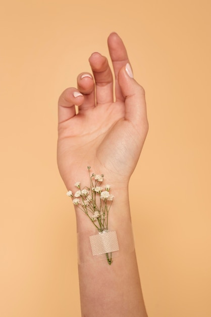 Close up hand with band aid and flowers