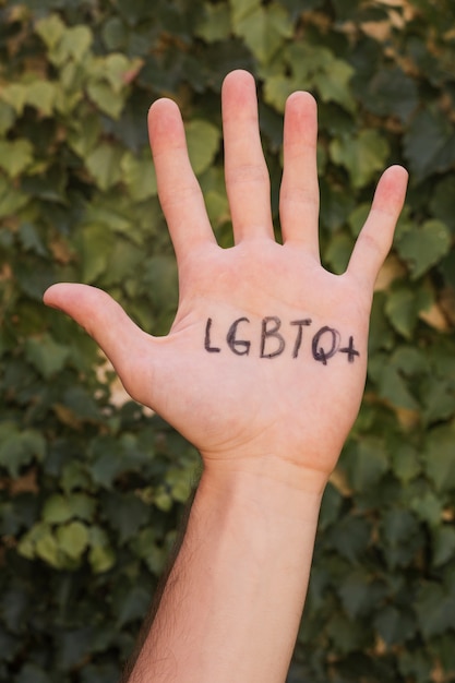 Close-up hand with gay pride initials