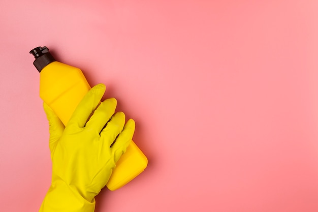 Close-up hand with glove holding detergent