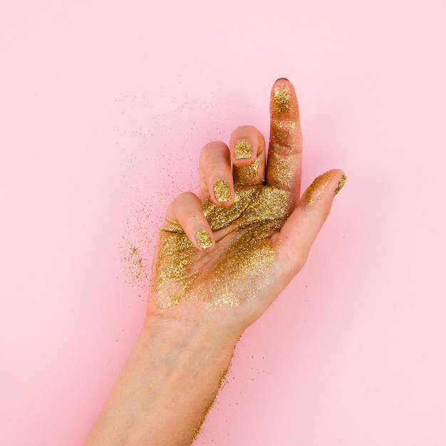 Close-up hand with golden glitter