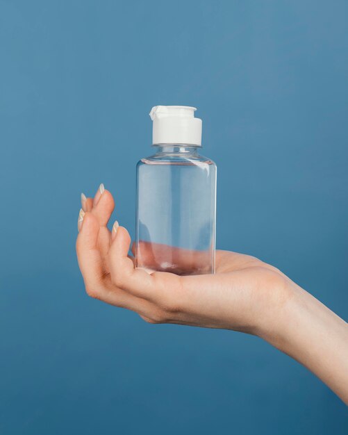 Close up hand with hand sanitizer bottle