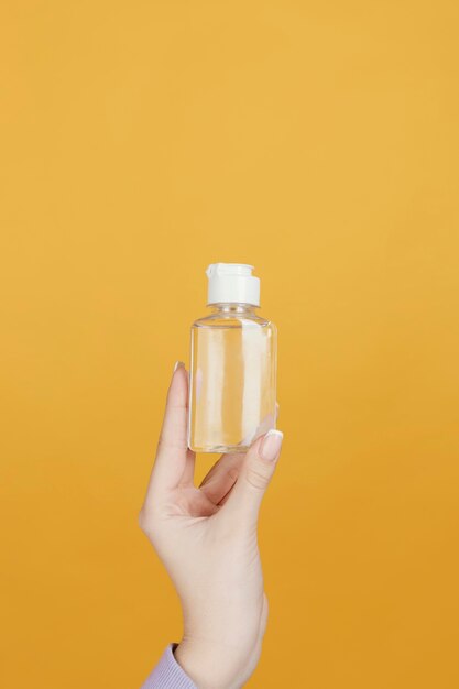 Close up hand with hand sanitizer bottle