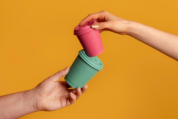 Close up on hand with reusable thermos