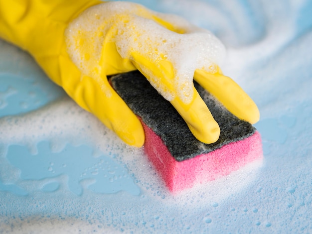 Free photo close-up hand with rubber glove cleaning