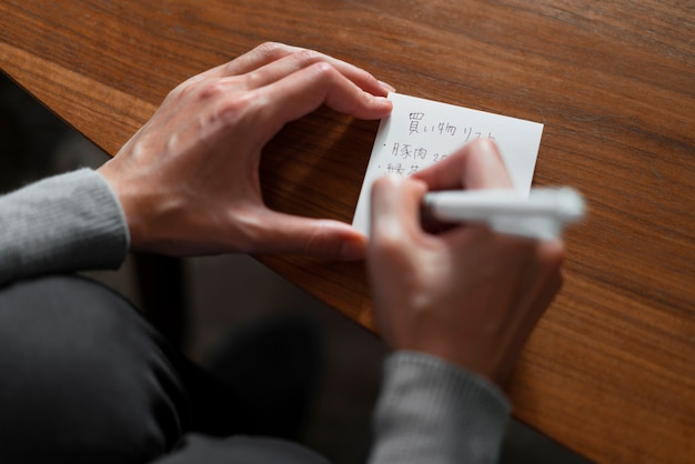 Close-up hand writing message in japanese