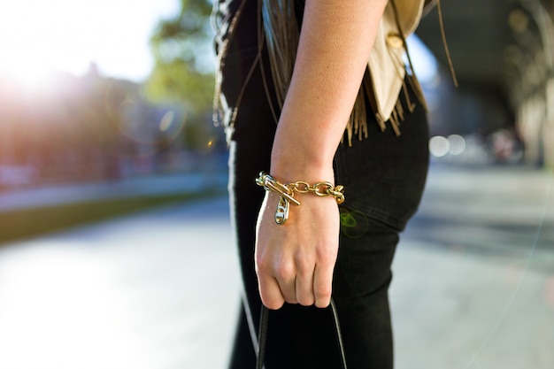 Close-up of hand of a young woman in the street.