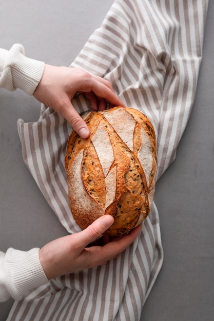 Close-up hands arranging bread