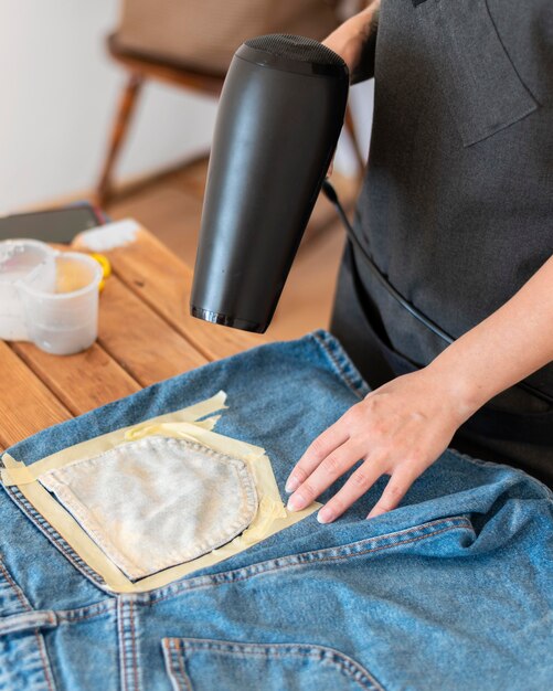 Close-up hands blow drying shorts