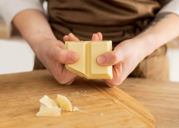 Close up hands breaking chocolate