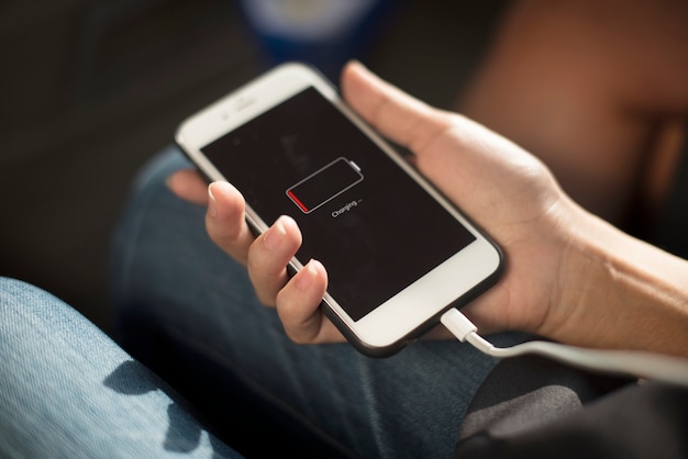 Close up of hands charging mobile phone