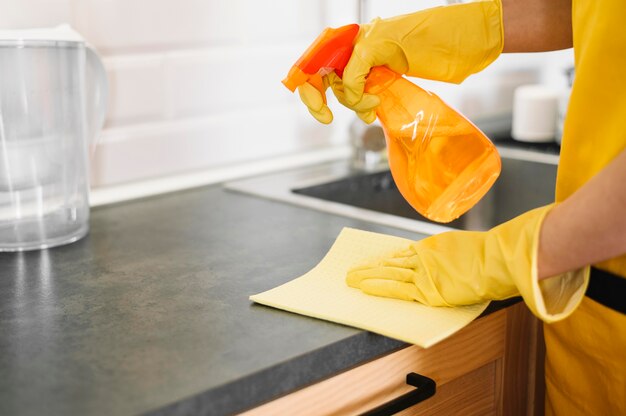 Close-up hands cleaning cabinet