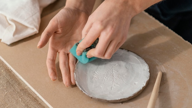 Close-up hands cleaning plate