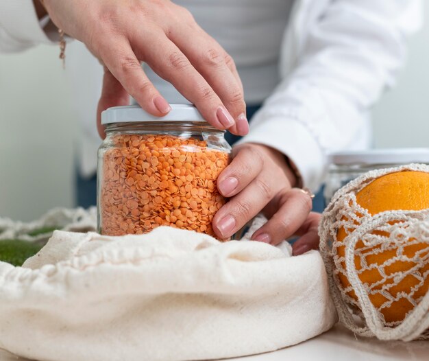 Close up hands closing jar