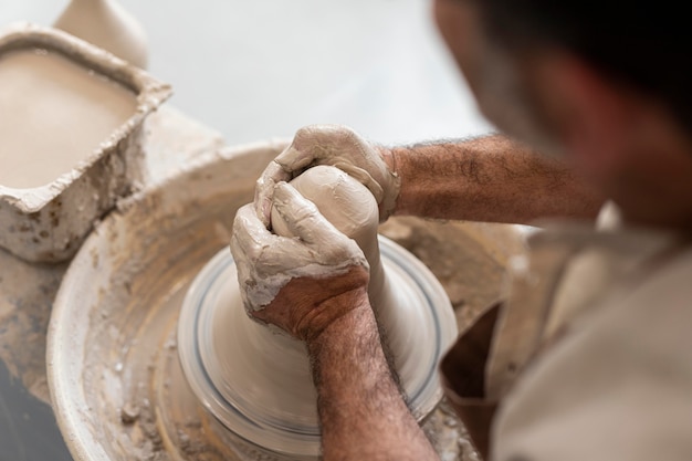 Close up hands creating pot