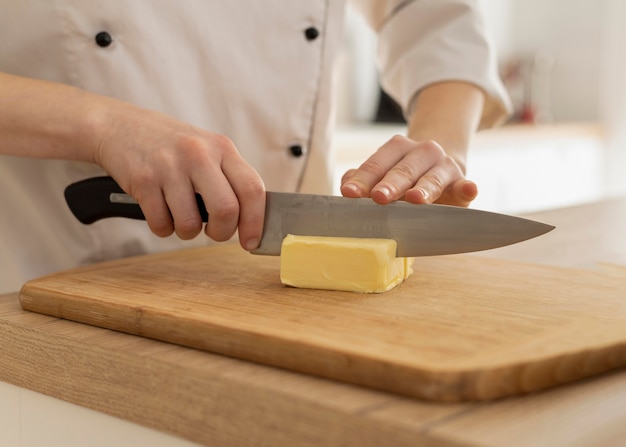 Close up hands cutting butter