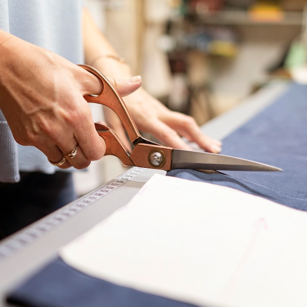 Close-up hands cutting material