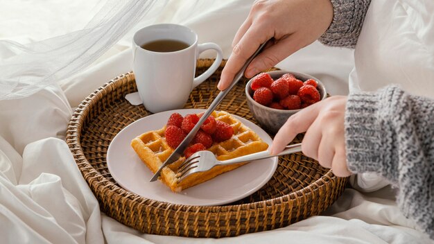 Close-up hands cutting waffle