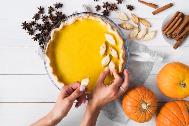 Close-up hands decorating pie