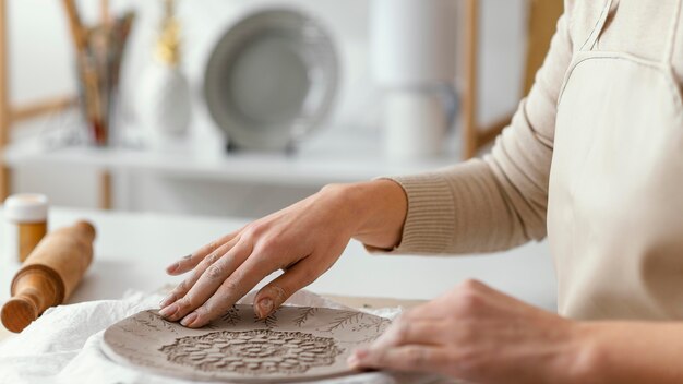 Close-up hands decorating plate