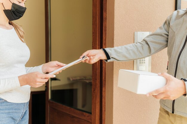 Close-up hands delivering package