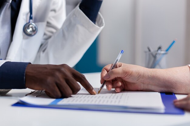 Close up of hands on desk at healthcare clinic