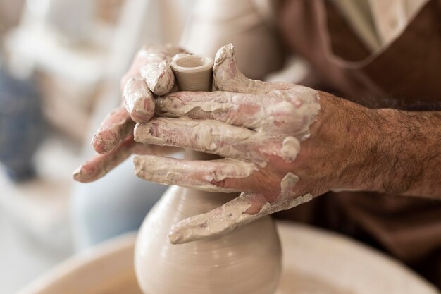 Close up hands doing pottery as hobby