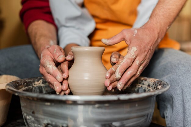 Close up hands doing pottery