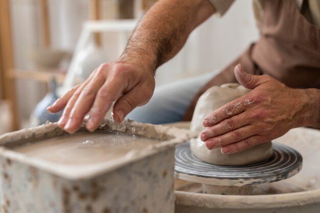 Close up hands doing pottery