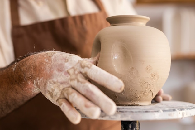 Close up hands doing pottery