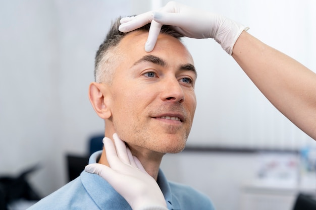 Free photo close up hands examining patient