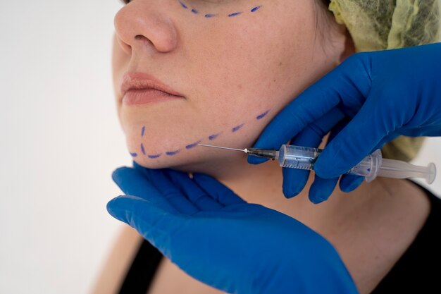 Close up hands giving injection to young woman