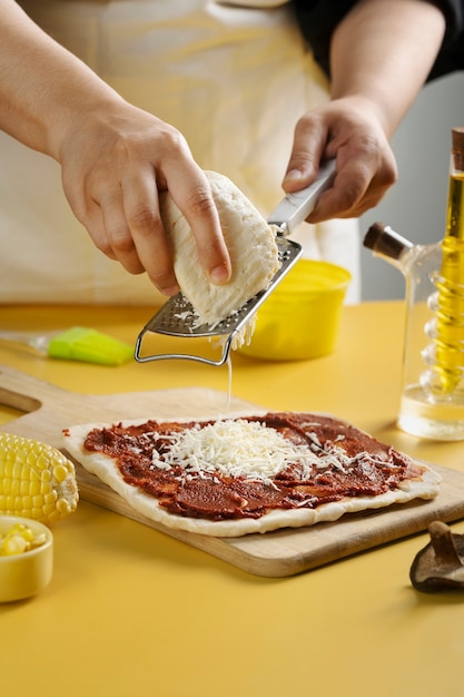 Close up hands grating cheese