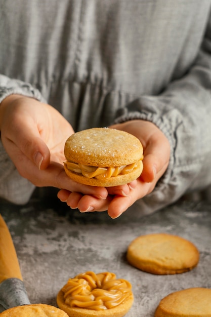 Close up  hands holding alfajores