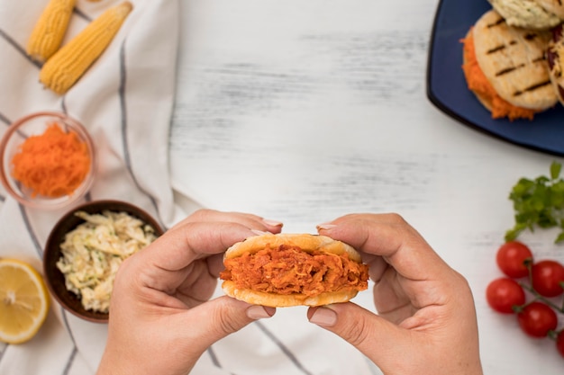 Close-up hands holding arepas