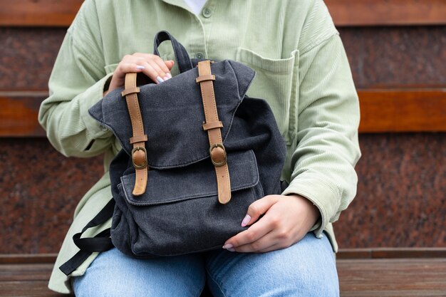 Close up hands holding backpack