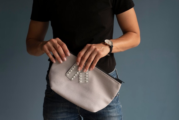 Free photo close up hands holding beauty bag