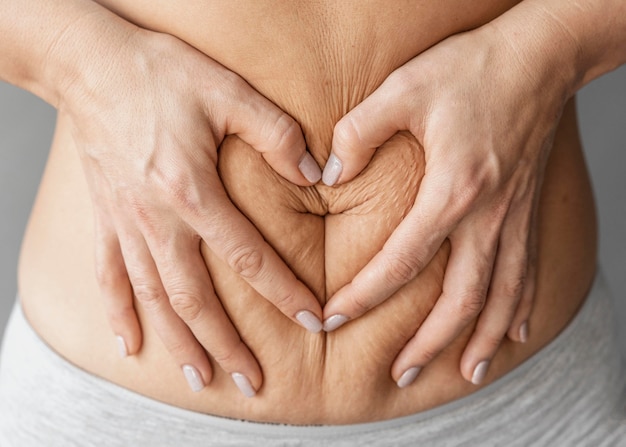 close up hands holding belly