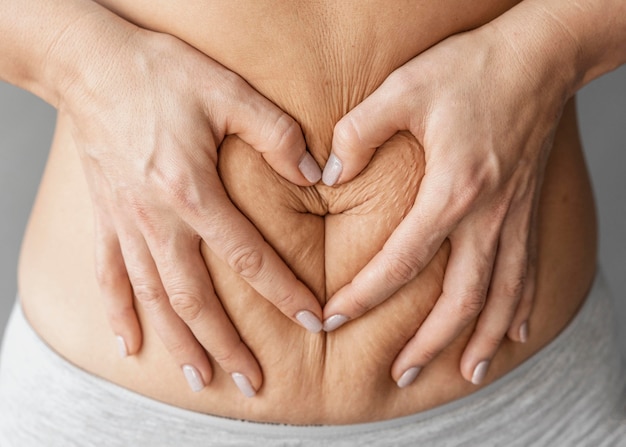 Free photo close up hands holding belly