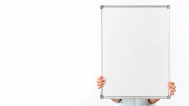 Close-up hands holding blank board