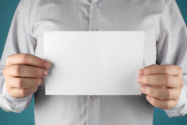 close up hands holding blank paper