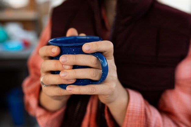 Free photo close up hands holding blue cup