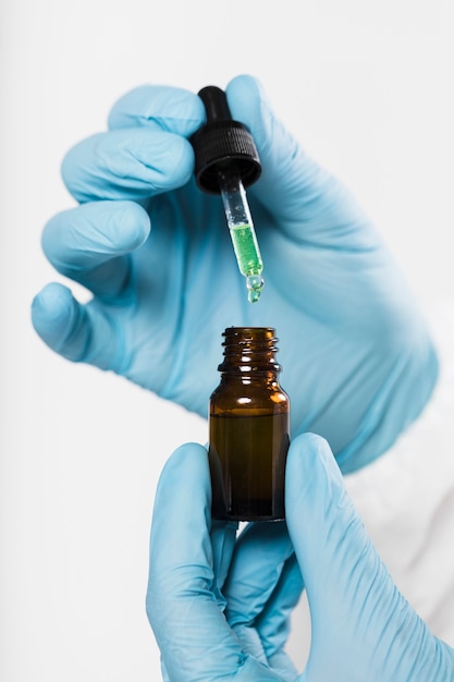 Close-up hands holding bottle with medical treatment